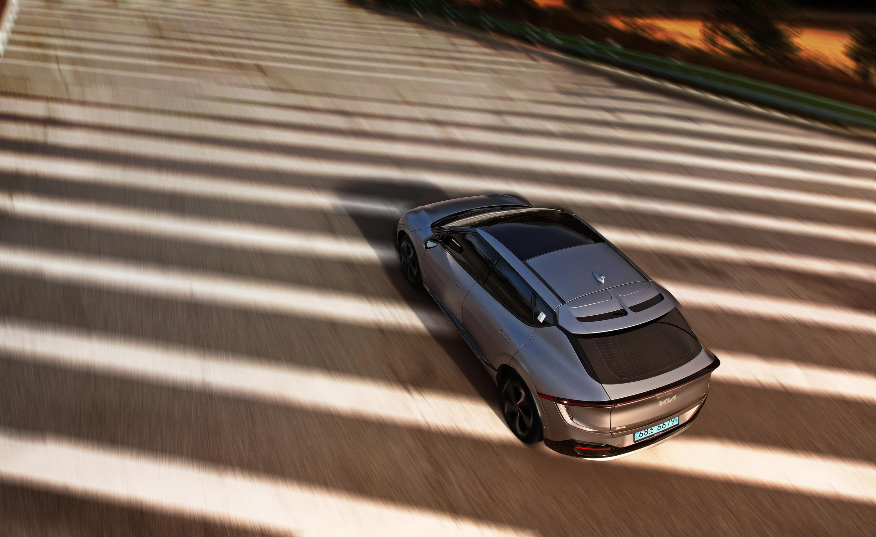 Hyundai EV cruising on road.