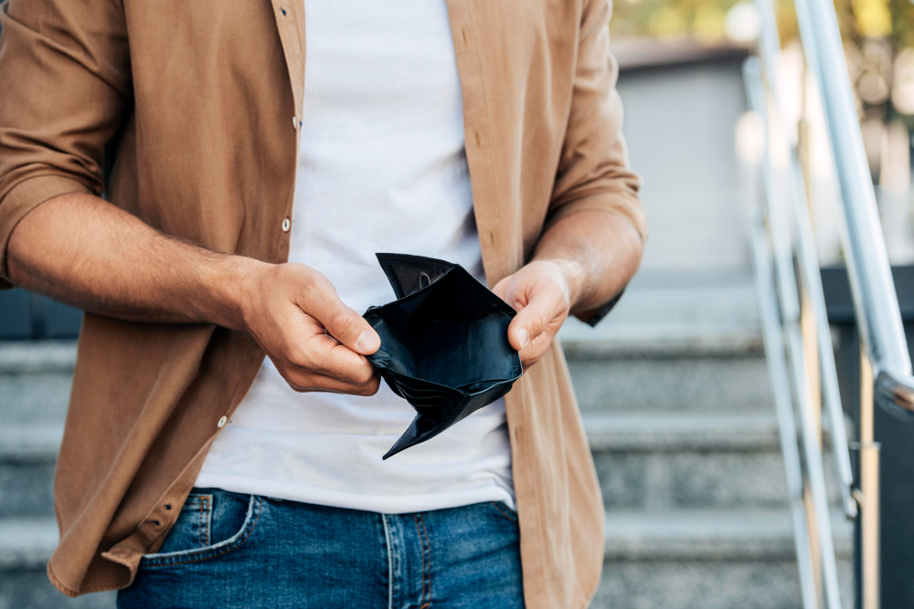 Man showing empty wallet