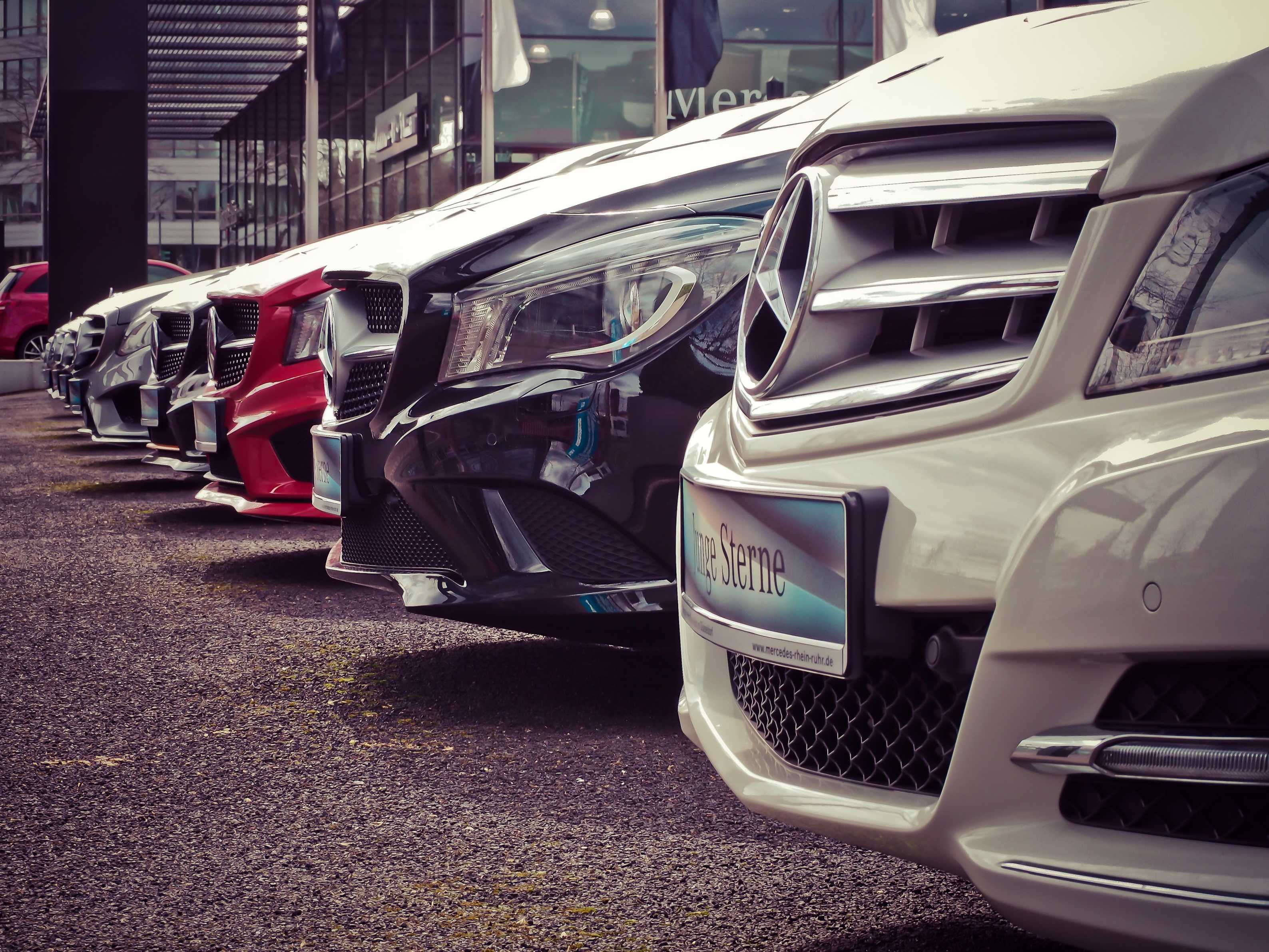 Cars lined up outside a car dealership.